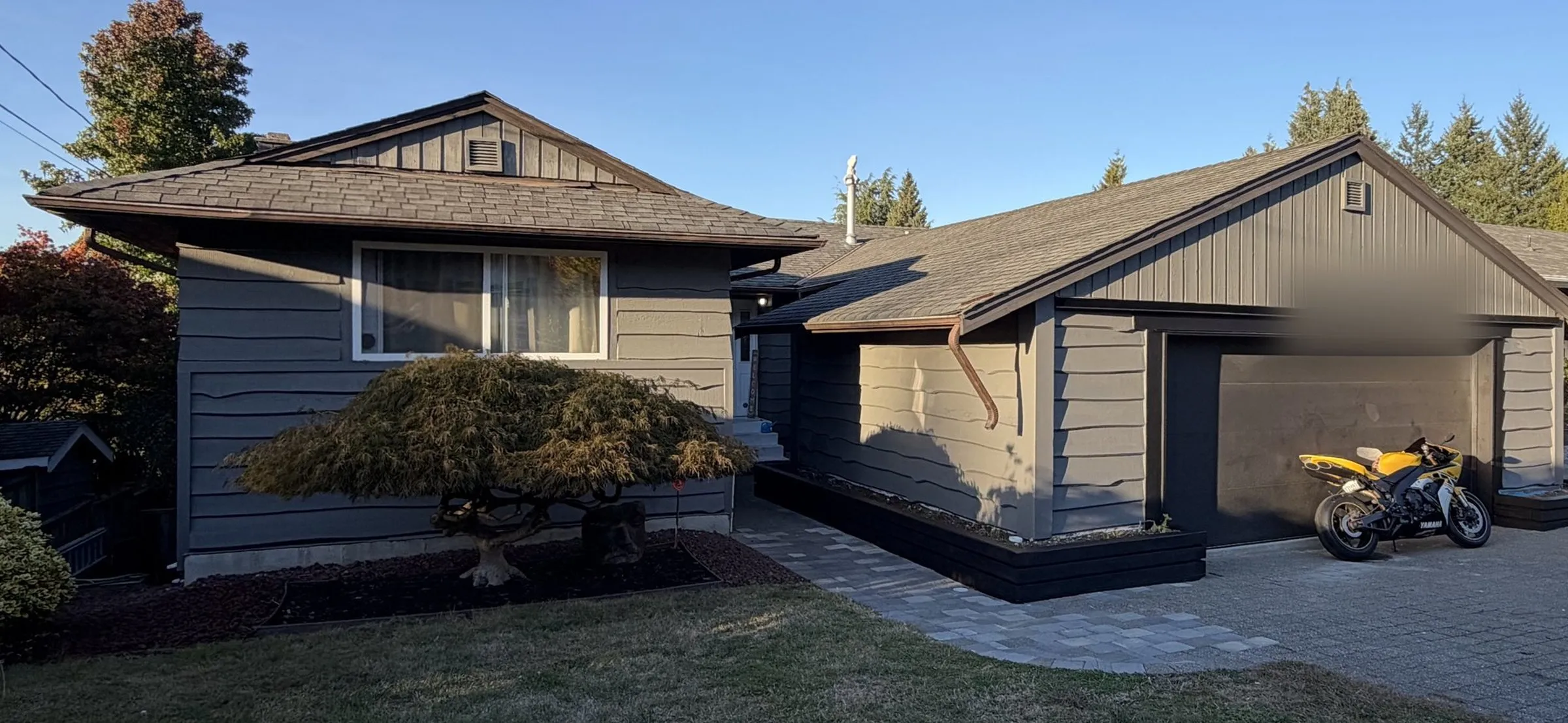 After: Finished grey garage with black door, converted from an open carport